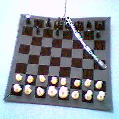 A chain of paperclips swinging on the king.